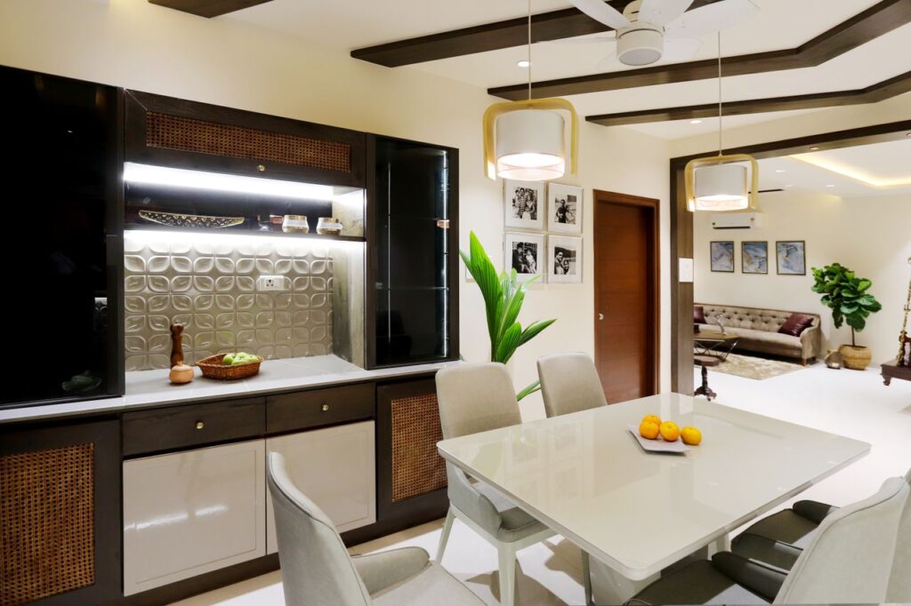 A sleek dining space featuring a modern table, stylish lighting, and elegant interior decor.